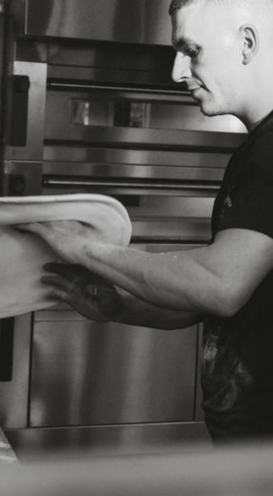 Man making pizza out of dough